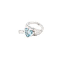 A blue topaz and diamond arrow heart ring