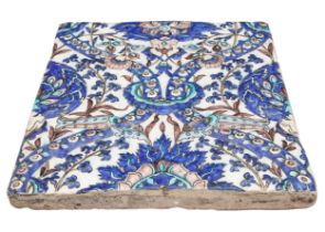 Persian, Qajar, 19th Century, A moulded tile with mixed tulips and arches, the background white with