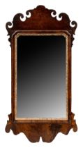 18th century, A walnut veneer pier mirror, with old glass and gilded inner