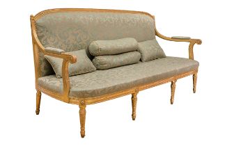 18th Century, An English giltwood three-seater settee, upholstered in green silk