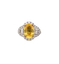 A yellow sapphire and diamond cocktail dress ring