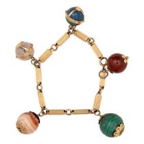 Circa 1950, An unusual gold and gem set charm bracelet