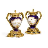 A pair of Louis XV gilt-bronze mounted Vincennes bleu lapis porcelain pots pourris and covers, the p