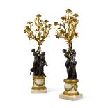 A pair of Louis XVI style gilt and patinated bronze five-light candelabra, late 19th century