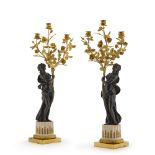 A pair of Louis XVI style gilt and patinated bronze three-light candelabra, late 19th century