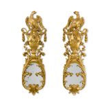 A pair of George II carved giltwood girandole wall mirrors, circa 1740, in the manner of William Ken