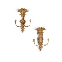 A pair of late George III carved giltwood two-branch wall lights, circa 1800