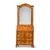 A George I walnut and parcel-gilt bureau cabinet, circa 1725