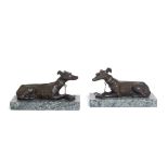 A pair of Regency bronze models of recumbent greyhounds, first quarter 19th century