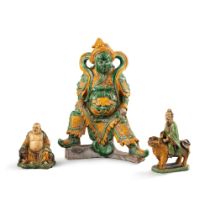 A large sancai-glazed figure of a guardian and two sancai-glazed figures of luohans, 19th &#8211; 20