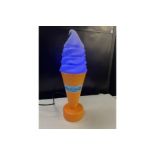 Illuminated ice cream cone display.
