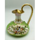 A BLOOR DERBY JUG DECORATED IN GREEN ENAMELS AND ENCRUSTED FLOWERS A/F