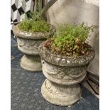 PAIR OF CONCRETE URNS ON PLINTHS