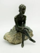 BRONZE FIGURE OF SEATED WOMAN WITH CROSSED LEGS