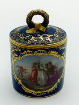 A MEISSEN PORCELAIN CUP WITH A LID AND BRACKET HANDLE WITH CARTOUCHES SHOWING MYTHOLOGICAL SCENES