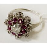 18CT WHITE GOLD SINGLE DIAMOND RING - 0.50CTS APPROX WITH RUBY HALO RING SIZE O