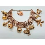 9 CARAT GOLD GATE BRACELET WITH MIXED GOLD CHARMS - APPROX 53 GRAMS