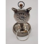 HM SILVER HALF HUNTER POCKET WATCH ON METAL STAND WITH A METAL BEZEL