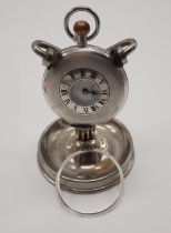 HM SILVER HALF HUNTER POCKET WATCH ON METAL STAND WITH A METAL BEZEL