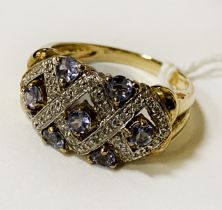 9CT GOLD TANZANITE & DIAMOND DRESS RING CONSISTING OF 7 ROUND BRILLIANT CUT TANZANITE & 34 ROUND