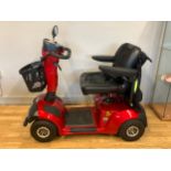 A Mercury Neo 8 mobility scooter, red, 8mph top speed with a 20 mile range on a full charge,