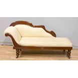 A Victorian mahogany framed chaise lounge, with carved floral decoration back and front rail,