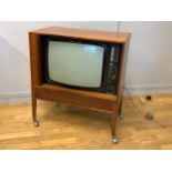 A PYE CRT Tv (Model CT22b series 741), in a teak case, on tapered legs with castors, 74cm x 84cm x