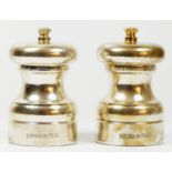 A pair of silver salt and pepper grinders, Birmingham 2001, the salt with a gilt knob, 10cm