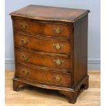 A serpentine fronted mahogany chest of drawers, four drawers with brass handles, on bracket feet,