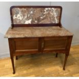 A early 20th century wash stand, marble top above and splash back over two hinged doors, 102cm x