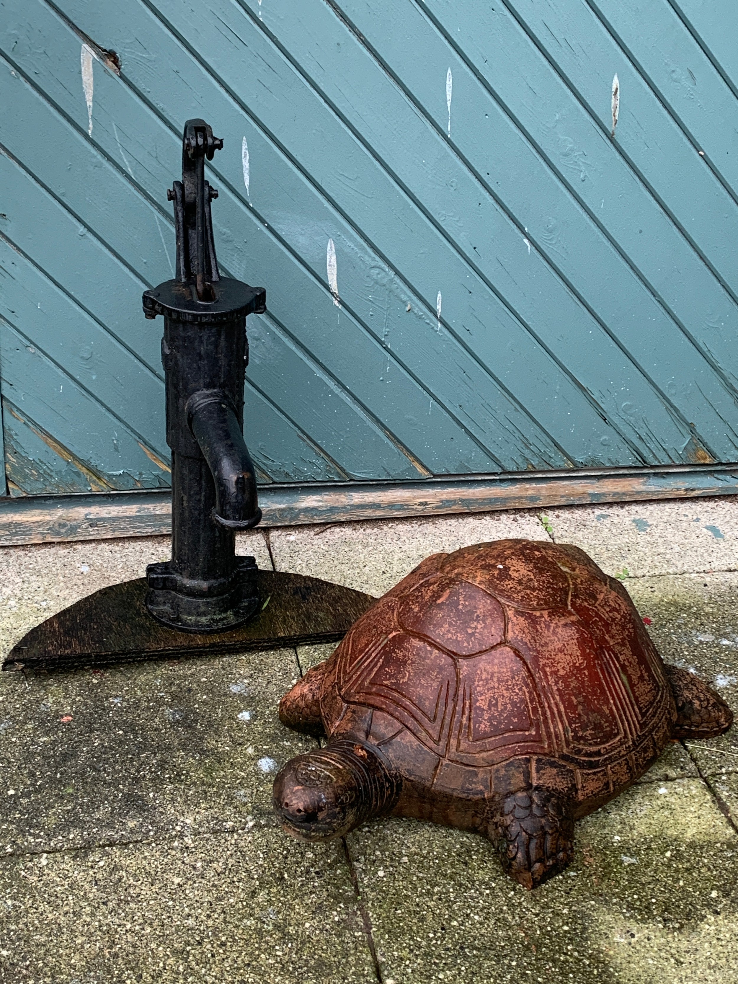 A cast iron pitcher pump water feature, 65cm tall, together with a large terracotta garden