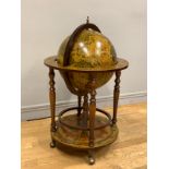 A drinks trolley in the form of a globe on base, hinged top opens to reveal a internally fitted