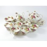 A Royal Chelsea 'Golden Rose' fine china tea service, comprising of six cups & saucers, six side