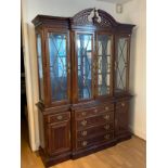 A Chippendale style inlaid mahogany breakfront cabinet sideboard, having pierced carved crest with