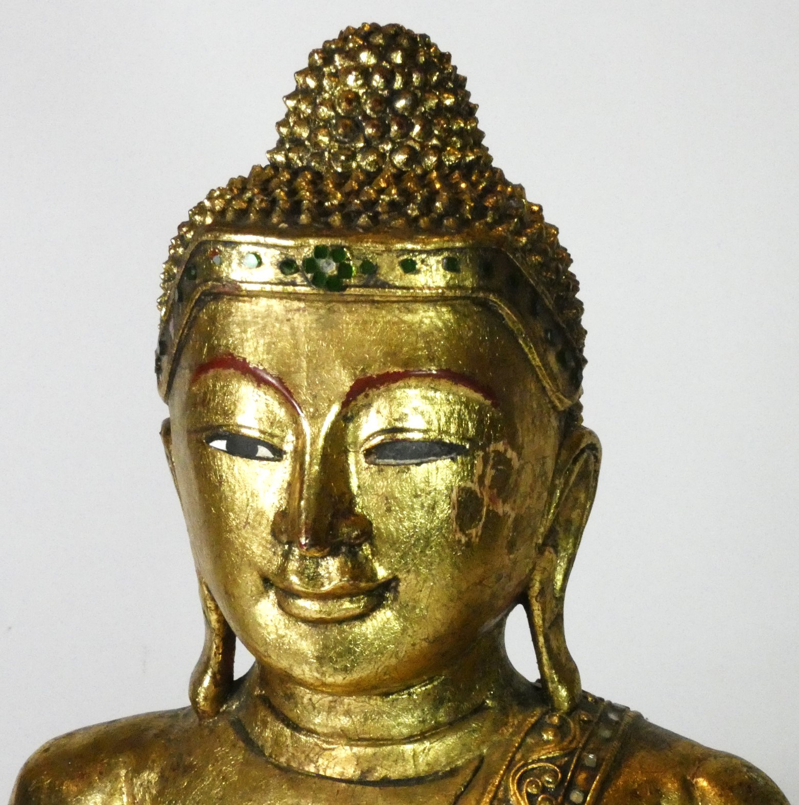 A seated carved wood Buddha, finely carved gilt scrollwork costume and headdress with inset glass - Image 2 of 3