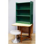 A Formica topped beech gate leg table, a green painted bookshelf and a footstool.