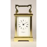 An English Wellington carriage clock, with enamelled dial and Roman numerals, incorporating a