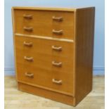 E. Gomme for G Plan, a light oak chest of two long drawers over three long drawers, signed to top