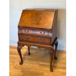 An Edwardian Queen Anne style mahogany drop front bureau, hinged front opening to reveal fitted