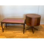 A 'Cameo Furniture' central drum table, having circular top with inset leather skiver above four