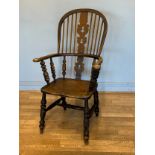 A late 19th early 20th century high back windsor chair, stick back with central carved splat, shaped