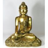 A seated carved wood Buddha, finely carved gilt scrollwork costume and headdress with inset glass