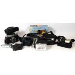 A collection of film and digital cameras, to include a Pentax Zoom 105-R, a Miranda Solo MD, A kodak