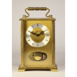 A mid 20th century German brass case mantel clock, having silvered chapter ring with roman numerals,