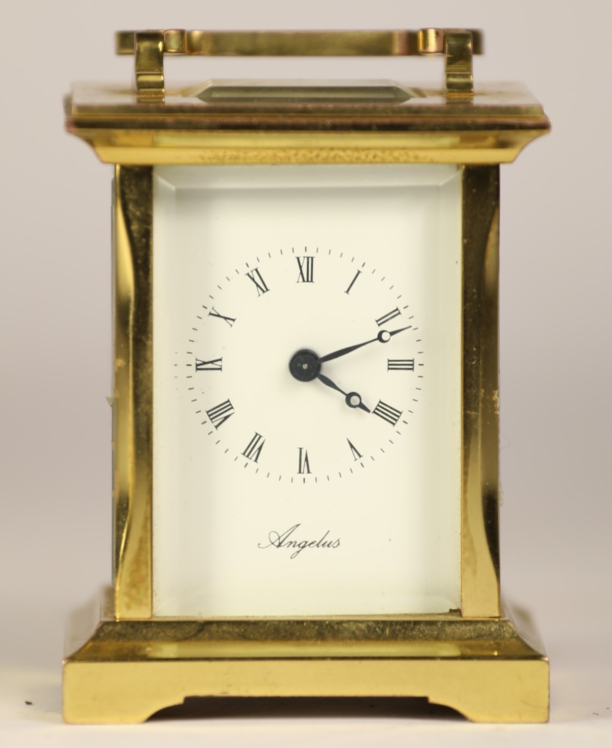 An English miniature brass carriage clock, having enamelled dial with Roman numerals, 8 day jewelled