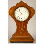 An Art Nouveau style inlaid mahogany balloon clock, with brass bezel and white enamelled dial,