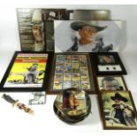 A collection of John Wayne and related memorabilia, including DVDs such as Dawn Rider, Texas