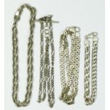 A silver flattened curb link chain, two other silver chains and a silver bracelet, 99gm