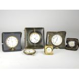 Four 1920s/30s 8 day traveling clocks, together with two 1950s/60s miniature folding travel