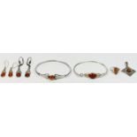 Two silver and amber Celtic bangles, two pairs of ear pendants, a ring and a pendant, 32gm.